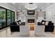 Cozy living room with a fireplace, hardwood floors, two large sofas, shelving, and a modern chandelier at 504 Trinity Church Rd, Canton, GA 30115