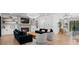 Bright, modern living room with hardwood floors, fireplace, and elegant light fixtures at 504 Trinity Church Rd, Canton, GA 30115