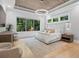 Stunning main bedroom with wood plank ceiling, light hardwood floors, and serene views at 504 Trinity Church Rd, Canton, GA 30115