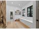 Well-organized mudroom with custom built-in bench, storage, and ample natural light from black framed windows at 504 Trinity Church Rd, Canton, GA 30115