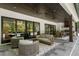 Covered patio featuring an outdoor kitchen, comfortable seating and views of the backyard pool area at 504 Trinity Church Rd, Canton, GA 30115