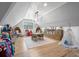 Bright playroom boasts wood floors, modern lighting, seating, and fun storage at 504 Trinity Church Rd, Canton, GA 30115