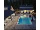 Aerial view of a stunning pool area with an outdoor kitchen and surrounding trees at twilight at 504 Trinity Church Rd, Canton, GA 30115