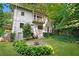 Beautiful backyard featuring a stone patio with a fire pit, lush lawn, and manicured landscaping at 118 Chelsea Dr, Decatur, GA 30030