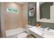 Neutral bathroom with a shower over the tub, framed mirror, and green accent wall at 118 Chelsea Dr, Decatur, GA 30030