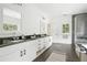 Bright bathroom featuring double vanity, sleek countertops and glass enclosed shower at 118 Chelsea Dr, Decatur, GA 30030