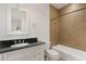 Tiled bathroom features a vanity with black countertop and shower over tub at 118 Chelsea Dr, Decatur, GA 30030