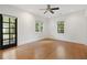 Bright bedroom with hardwood floors, ceiling fan, and door to the porch at 118 Chelsea Dr, Decatur, GA 30030