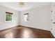 Bright bedroom with hardwood floors, natural light from two windows, and closet at 118 Chelsea Dr, Decatur, GA 30030