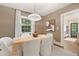 Stylish dining room with natural light, modern lighting and an open doorway to the kitchen at 118 Chelsea Dr, Decatur, GA 30030
