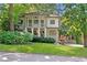 Charming two-story home with a columned front porch and balcony nestled among mature trees and manicured lawn at 118 Chelsea Dr, Decatur, GA 30030