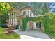 Two-story home with charming curb appeal and a vine-covered carport at 118 Chelsea Dr, Decatur, GA 30030