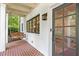 Inviting front porch with classic brick flooring and a charming wooden swing at 118 Chelsea Dr, Decatur, GA 30030