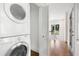 Convenient laundry area features a stacked washer and dryer and opens into a hallway at 118 Chelsea Dr, Decatur, GA 30030
