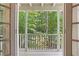 View from a porch overlooking lush greenery and trees through open french doors at 118 Chelsea Dr, Decatur, GA 30030