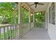 Covered porch with ceiling fan overlooks a serene yard with lush trees and plantings at 118 Chelsea Dr, Decatur, GA 30030