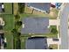 An aerial view of a home with well-maintained landscaping and a gray roof and a driveway at 320 Pebblestone Ln, Canton, GA 30115
