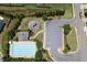 An aerial view of a community pool and playground with ample parking and manicured landscaping at 320 Pebblestone Ln, Canton, GA 30115