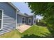 Cozy backyard with lush lawn, mature trees, and a patio area off the home's back at 320 Pebblestone Ln, Canton, GA 30115