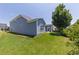 Large backyard with lush lawn, mature trees, and a patio area for outdoor entertaining at 320 Pebblestone Ln, Canton, GA 30115