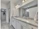 Bathroom with double sinks, granite countertops, and tiled shower with glass door at 320 Pebblestone Ln, Canton, GA 30115