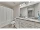 Bright bathroom features granite counters, double vanity, a bathtub, and shower with curtain at 320 Pebblestone Ln, Canton, GA 30115