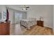 Well-lit bedroom with hardwood floors, a cozy bed, and ample natural light at 320 Pebblestone Ln, Canton, GA 30115