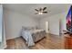 Comfortable bedroom featuring wood-look flooring, a ceiling fan, and a beautifully patterned bedspread at 320 Pebblestone Ln, Canton, GA 30115