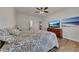 Bright bedroom with a ceiling fan, wood-look floors, and a dresser with a TV and mounted art at 320 Pebblestone Ln, Canton, GA 30115