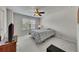 Comfortable bedroom with plush carpeting, a ceiling fan, and natural light at 320 Pebblestone Ln, Canton, GA 30115