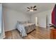 Comfortable bedroom with hardwood floors, a ceiling fan, and plenty of space at 320 Pebblestone Ln, Canton, GA 30115