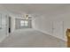 Large bonus room with carpet, a ceiling fan, and several doors at 320 Pebblestone Ln, Canton, GA 30115