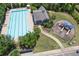 Aerial view of the community pool and playground with well-manicured lawns and mature trees at 320 Pebblestone Ln, Canton, GA 30115