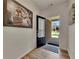 Bright foyer with hardwood floors and a glimpse of the exterior through the glass-paneled front door at 320 Pebblestone Ln, Canton, GA 30115