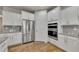 Modern kitchen with stainless steel appliances, granite countertops, and ample cabinet space at 320 Pebblestone Ln, Canton, GA 30115