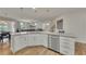 Bright, airy kitchen island with white cabinets, stainless steel appliances, and hardwood floors at 320 Pebblestone Ln, Canton, GA 30115