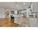 Well-lit kitchen with a spacious island, stainless steel refrigerator, and hardwood floors at 320 Pebblestone Ln, Canton, GA 30115