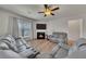Bright living room with hardwood floors, cozy fireplace, and comfortable seating at 320 Pebblestone Ln, Canton, GA 30115