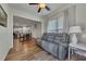 Inviting seating area with a reclining sofa, window, and open view to a modern kitchen at 320 Pebblestone Ln, Canton, GA 30115