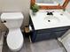 Updated bathroom with a sink, toilet, and a wooden framed mirror at 460 Heathrow Way, Stone Mountain, GA 30087