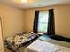 Bright bedroom with twin beds, window, and warm paint tones at 460 Heathrow Way, Stone Mountain, GA 30087