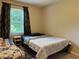 Cozy bedroom showcasing twin beds, natural light, and comfortable carpeting at 460 Heathrow Way, Stone Mountain, GA 30087