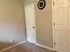 Neutral bedroom with a clock on the wall and two doors at 460 Heathrow Way, Stone Mountain, GA 30087