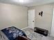 Bright bedroom with neutral paint, simple furnishings, and wall-mounted TV bracket at 460 Heathrow Way, Stone Mountain, GA 30087