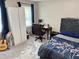Bedroom with white wardrobe, a desk and chair, tufted headboard, and ample natural light at 460 Heathrow Way, Stone Mountain, GA 30087