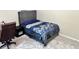 Stylish bedroom features a tufted headboard, modern decor, and soft neutral carpeting at 460 Heathrow Way, Stone Mountain, GA 30087