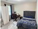 Cozy bedroom with a wardrobe, desk and chair, tufted headboard, and ample natural light at 460 Heathrow Way, Stone Mountain, GA 30087