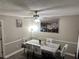 Classic dining room featuring ceiling fan, laminate flooring, and large canvas art at 460 Heathrow Way, Stone Mountain, GA 30087