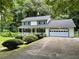 Charming two-story home with a front porch, attached garage and well-manicured landscaping at 460 Heathrow Way, Stone Mountain, GA 30087