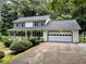 Charming two-story home with a front porch, attached garage and well-manicured landscaping at 460 Heathrow Way, Stone Mountain, GA 30087